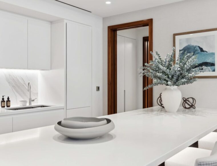 White kitchen with a built in dining table that is decorated with Ornaments.