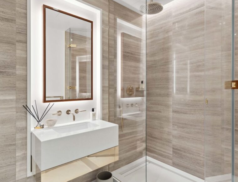 Bathroom with a walk-in shower and large mirror above the sink.